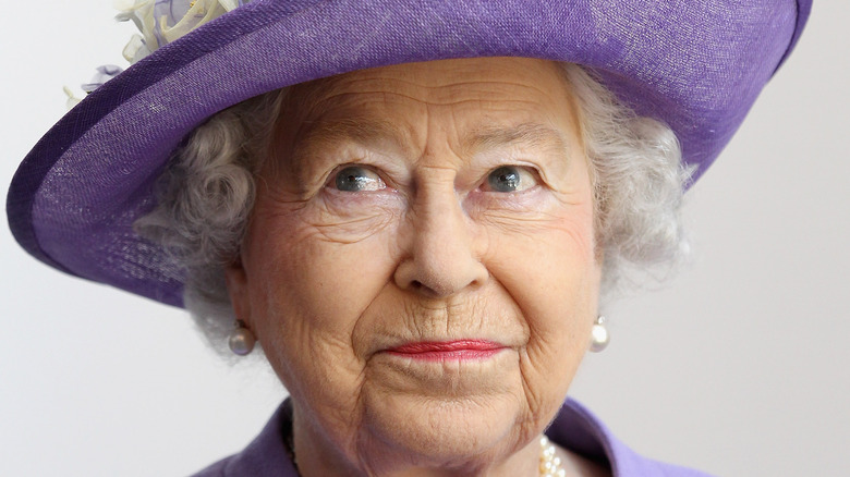 Queen Elizabeth gives a cheeky smile at an event