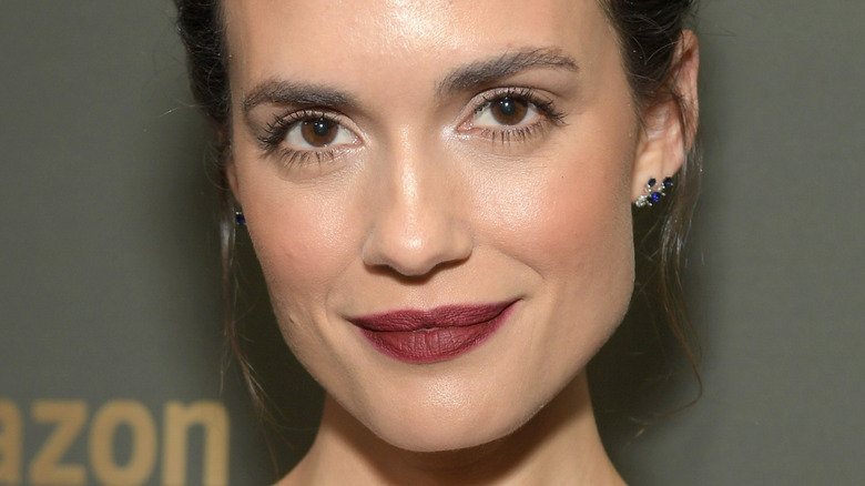 Torrey DeVitto smiling red lip blue earrings