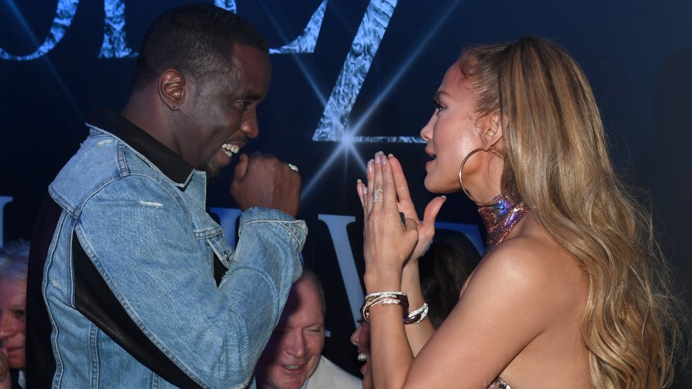 Sean Combs and Jennifer Lopez facing each other and smiling while speaking at her 2018 Las Vegas residency after party
