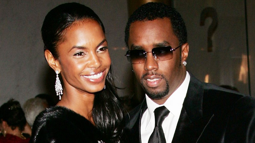 Kim Porter and Sean Combs, both wearing black and smiling at the 2004 Kennedy Center Honors