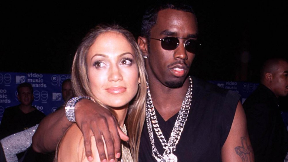 Jennifer Lopez, Sean Combs looking in opposite directions with neutral expressions at the 1999 MTV VMAs
