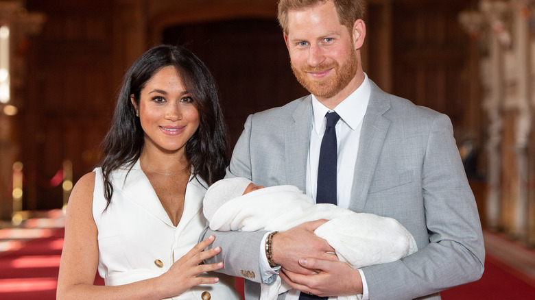 Prince Harry, Meghan Markle, and Prince Archie posing