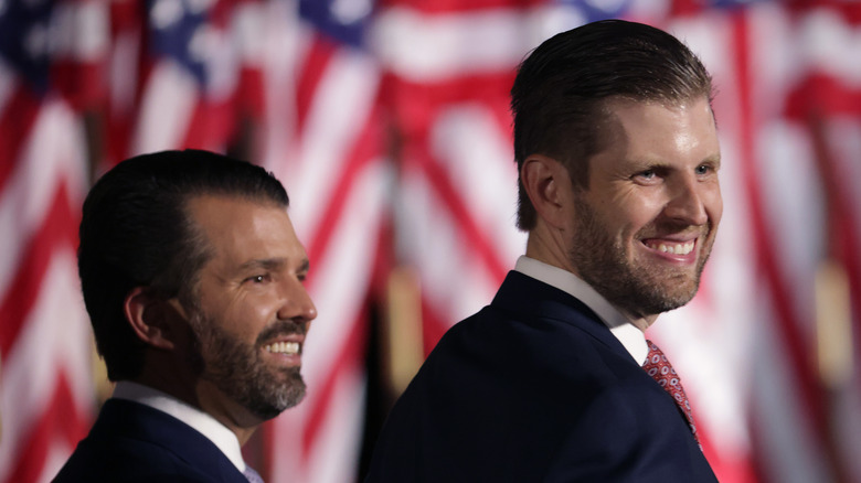 Donald Trump Jr. and Eric Trump look off to side smiling