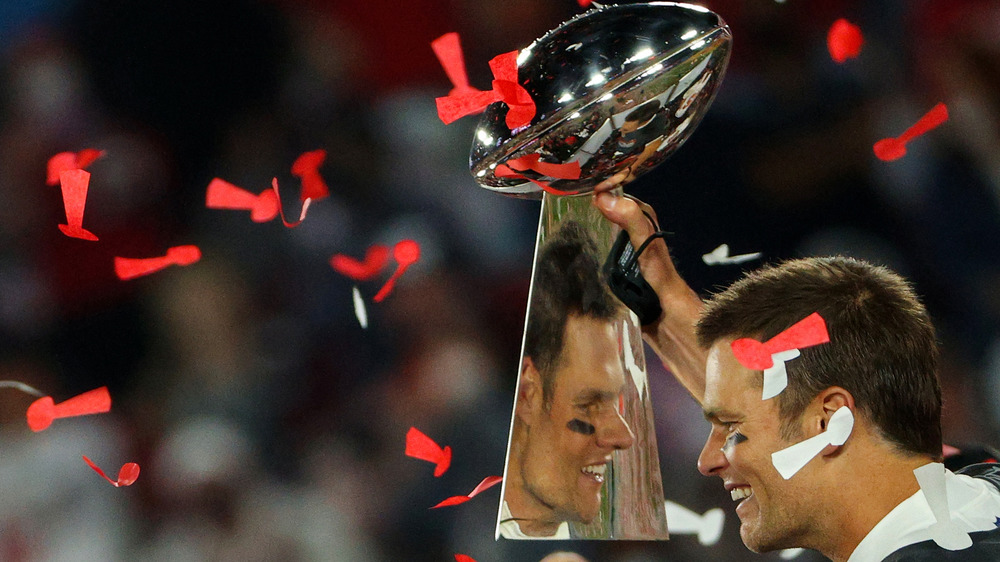 Tom Brady holding a trophy