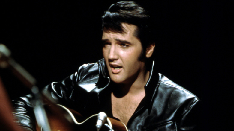 Elvis Presley wears black leather jacket while performing