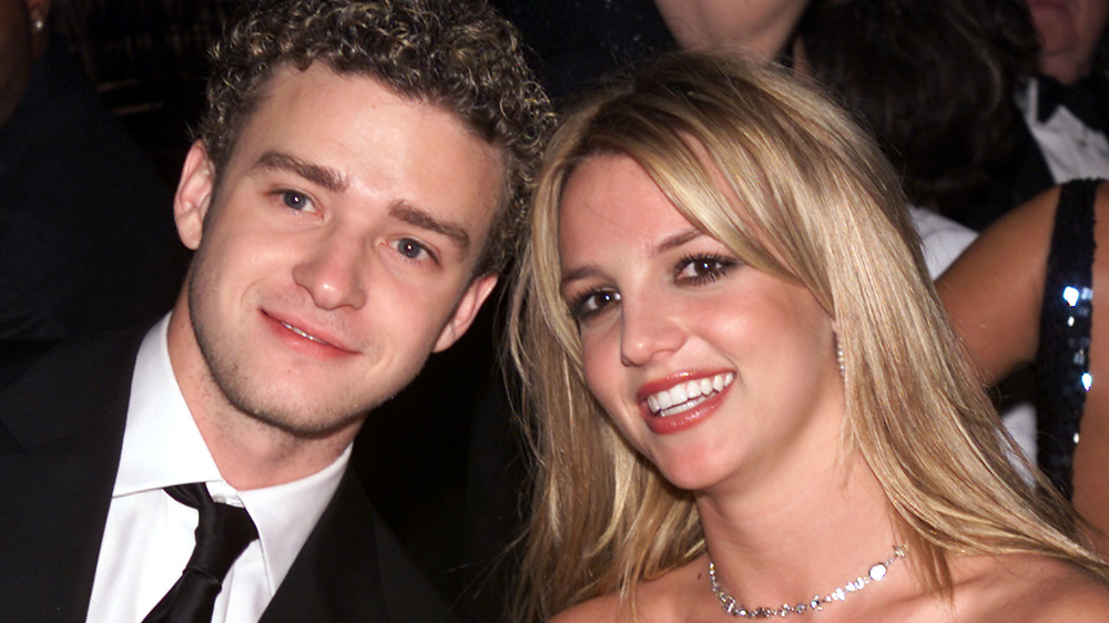 Justin Timberlake and Britney Spears smiling for the camera at an event