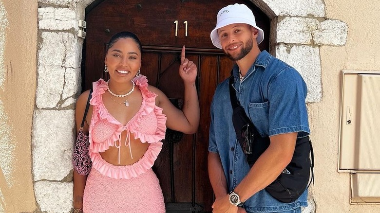 Ayesha, Steph Curry posing in front of door