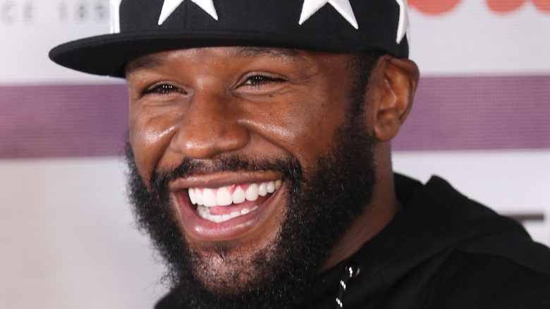 Floyd Mayweather smiles at an event