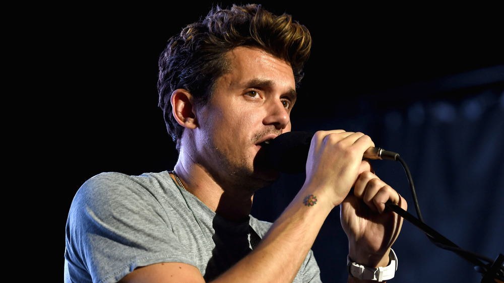 John Mayer singing into microphone