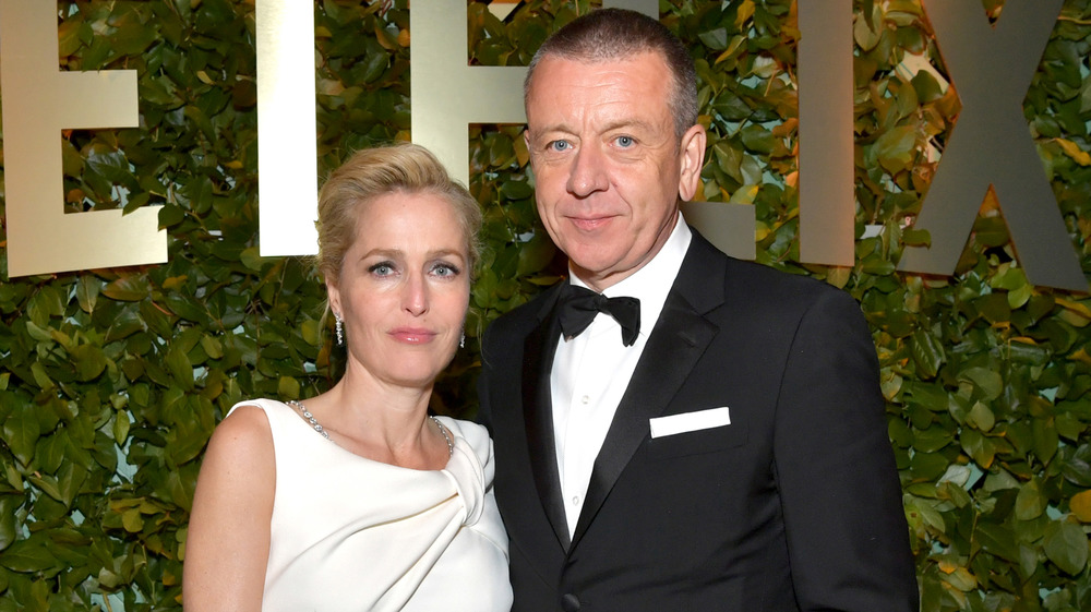 Gillian Anderson and Peter Morgan posing at an event