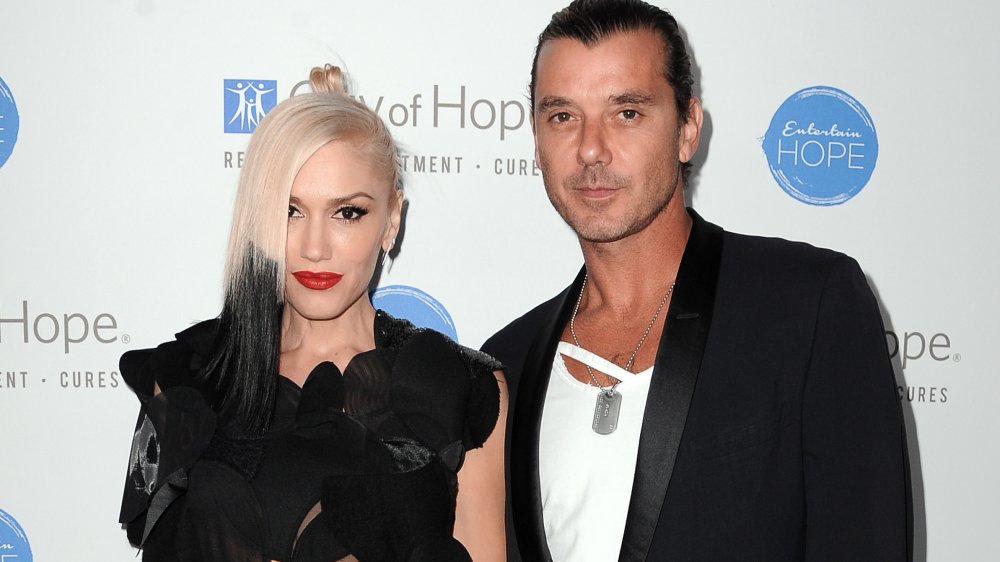 Gwen Stefani and Gavin Rossdale posing together with neutral expressions, both wearing black outfits