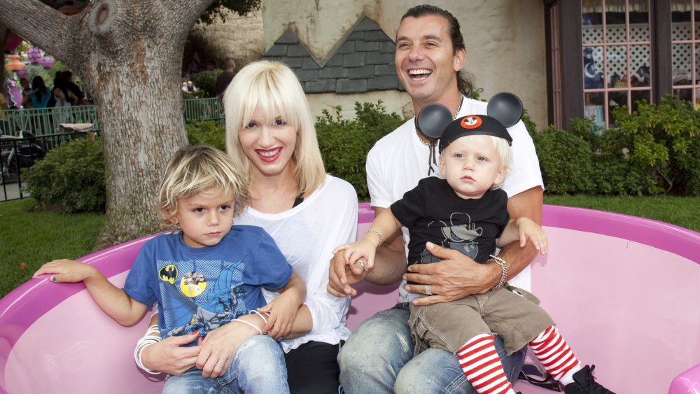 Gwen Stefani and Gavin Rossdale, smiling while outside with their kids