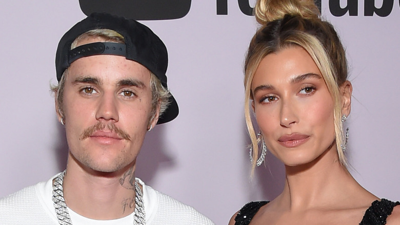 Hailey Baldwin bun Justin Bieber hat mustache