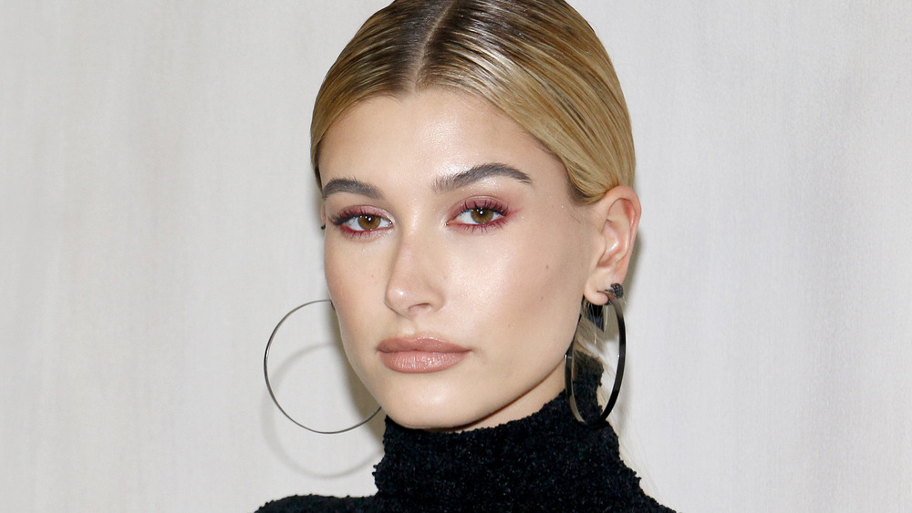 Hailey Bieber with a neutral expression