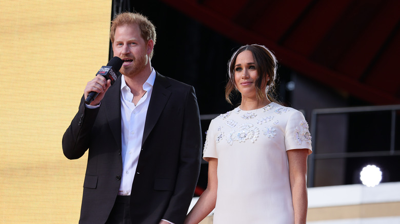 Prince Harry and Meghan Markle holding hands