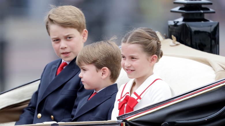 Prince George, Princess Charlotte, and Prince Louis sitting