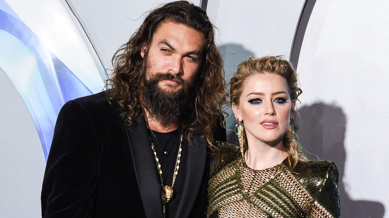 Amber Heard Jason Momoa posing on red carpet