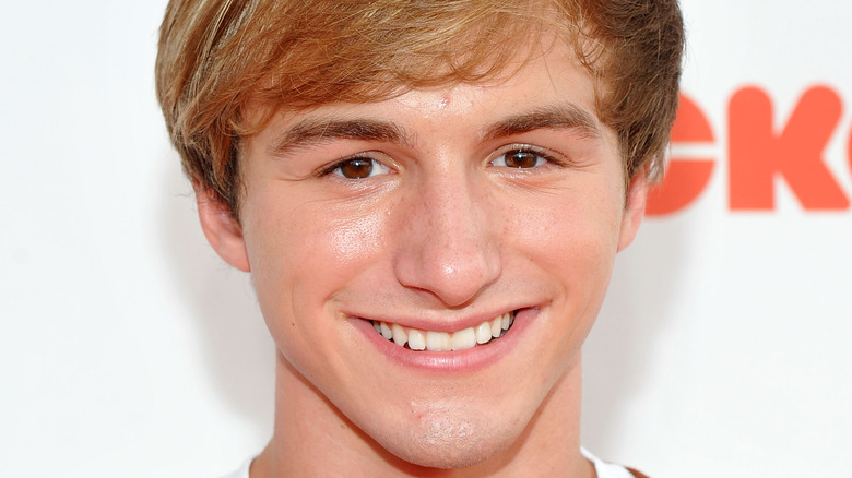 Lucas Cruikshank smiling with sideswept hair