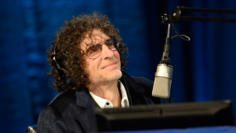 Howard Stern sitting at a microphone  