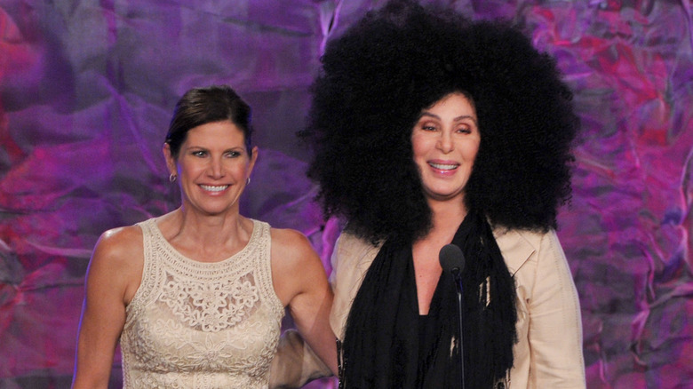 Mary Bono and Cher with giant hair on stage