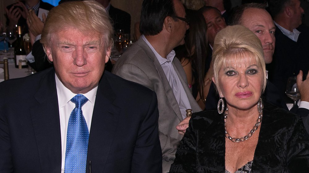 Donald Trump and Ivana Trump sitting at a dinner, both with neutral expressions