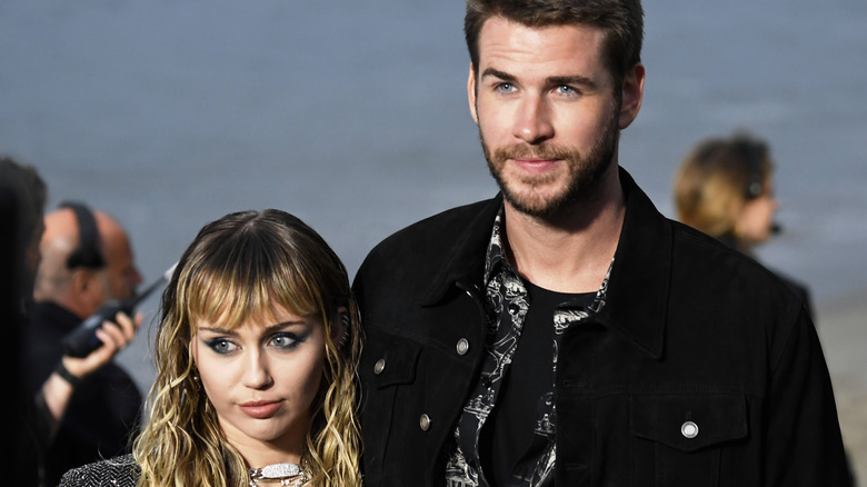 Miley Cyrus and Liam Hemsworth posing in 2019