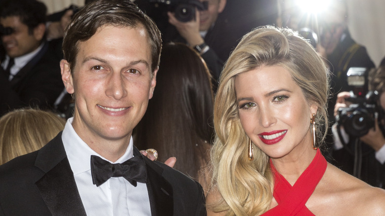 Jared Kushner and Ivanka Trump smile on a red carpet