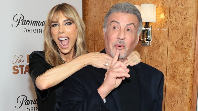 Jennifer Flavin playfully strangling Sylvester Stallone