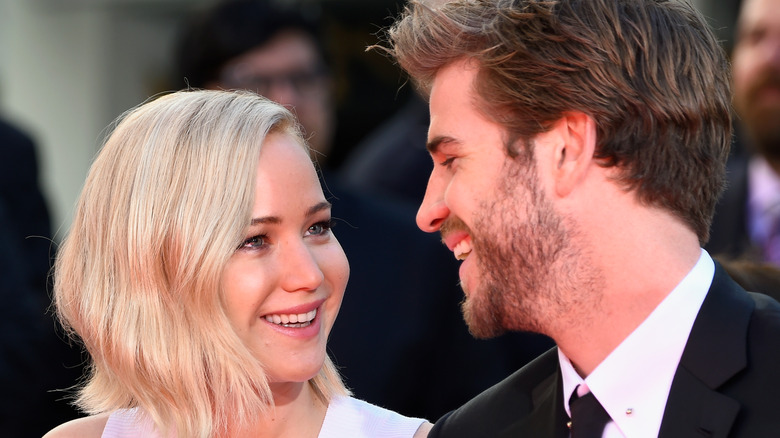 Jennifer Lawrence smiling at Liam Hemsworth