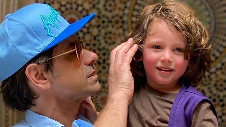 John Stamos holding Billy