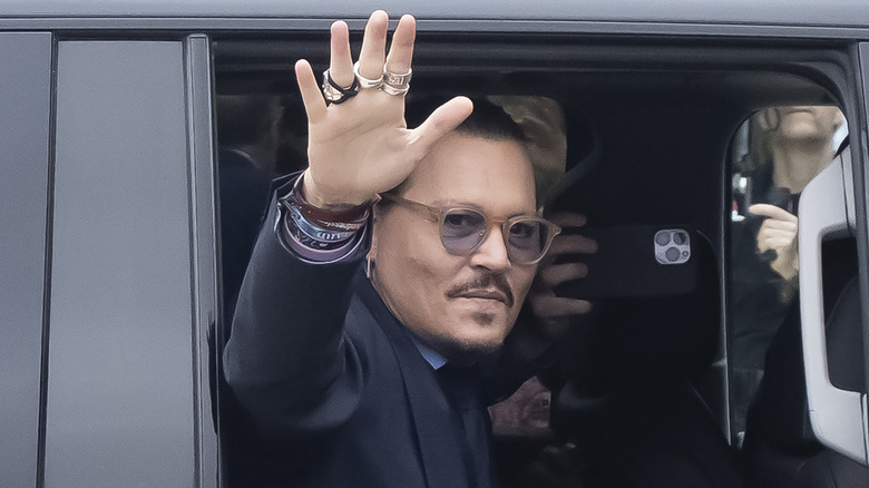 ohnny Depp gestures to fans during a recess outside court 