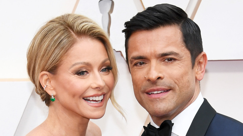 Kelly Ripa and Mark Consuelos smiling on the red carpet