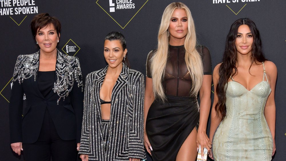 Kris Jenner, Kourtney Kardashian, Khloe Kardashian, and Kim Kardashian, all posing on E! red carpet