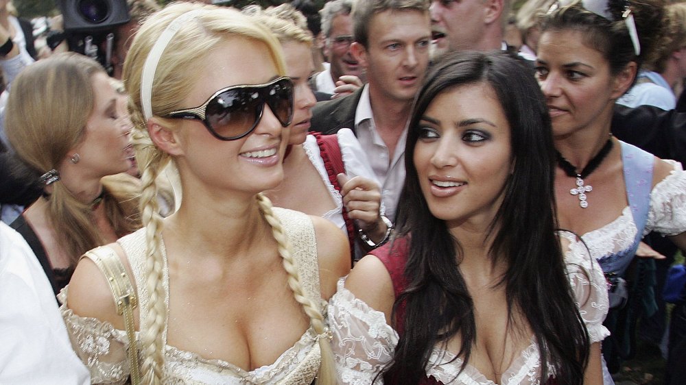 Paris Hilton and Kim Kardashian in a crowd, walking arm in arm