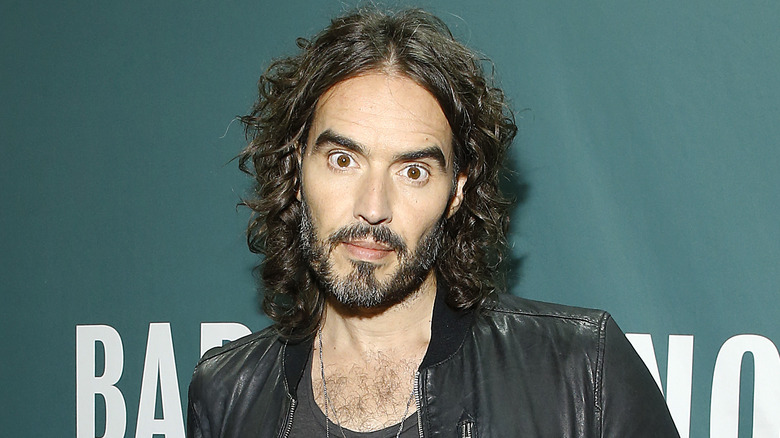 Russell Brand posing