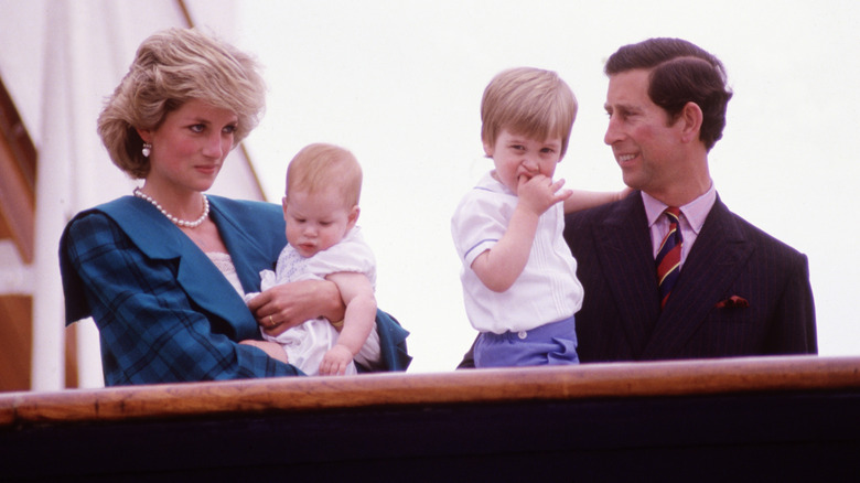 Princess Diana and King Charles holding Princes Harry and William