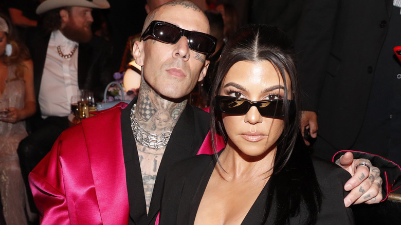 Travis Barker and Kourtney Kardashian posing