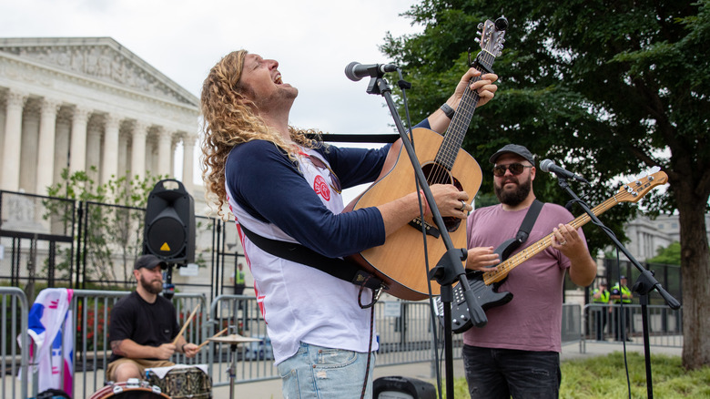 Sean Feucht sings while playing the guitar