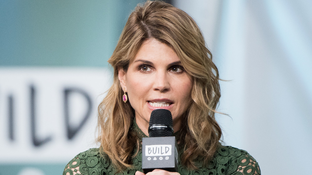 Lori Loughlin speaking into a microphone