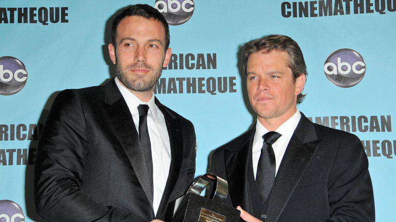 Ben Affleck and Matt Damon holding an award