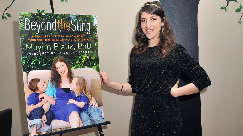 Mayim Bialik posing with poster