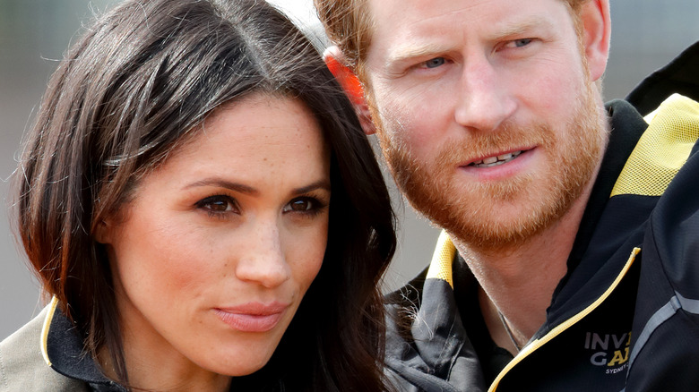 Meghan Markle and Prince Harry looking serious