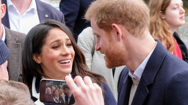 Prince Harry and Meghan Markle in street