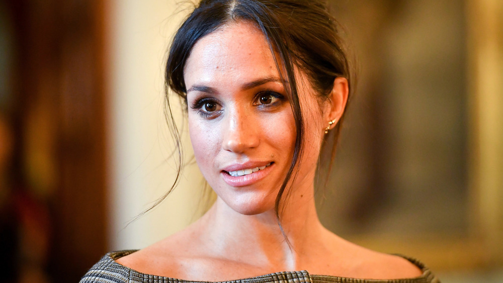 Meghan Markle with a neutral expression