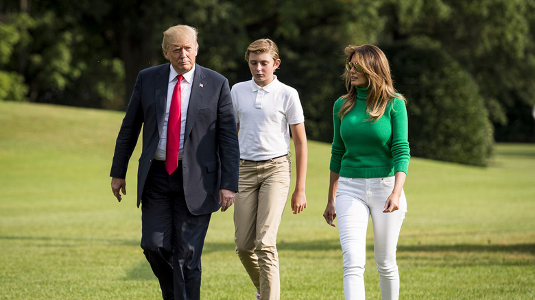 Donald, Barron, and Melania Trump walking