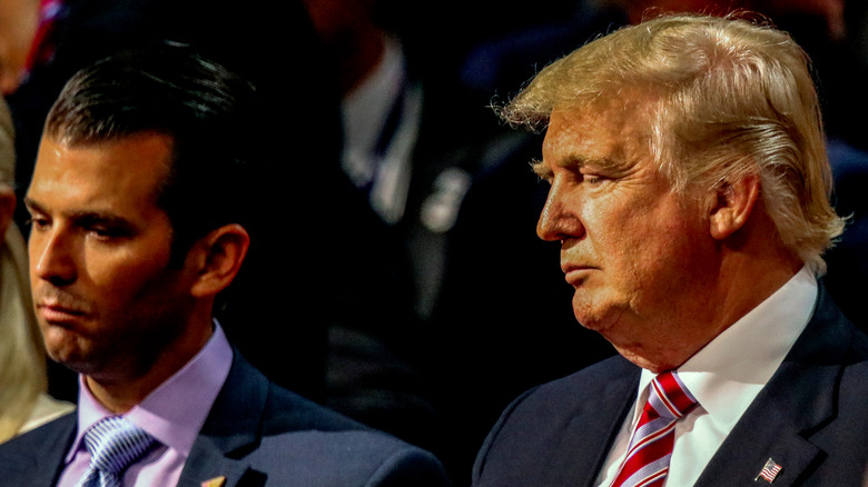 Donald Trump Jr. and Donald Trump looking somber at an event