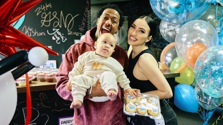 Nick Cannon and Bre Tiesi smiling with their kid