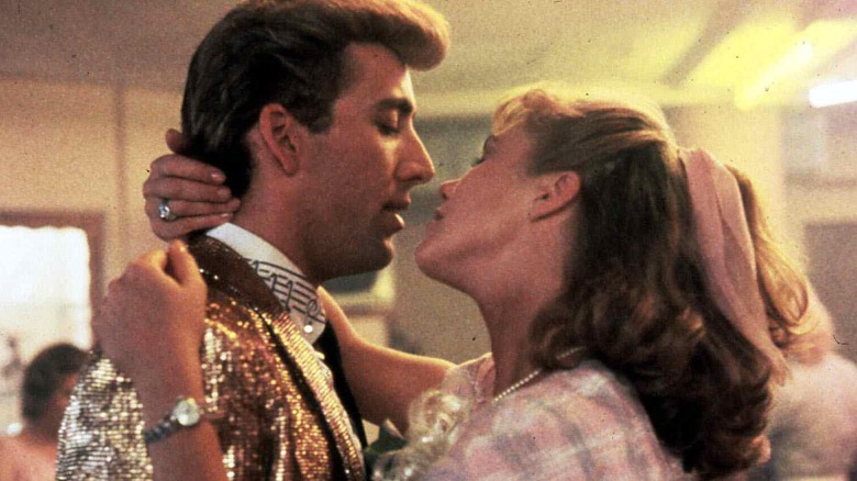 Nicolas Cage and Kathleen Turner embracing