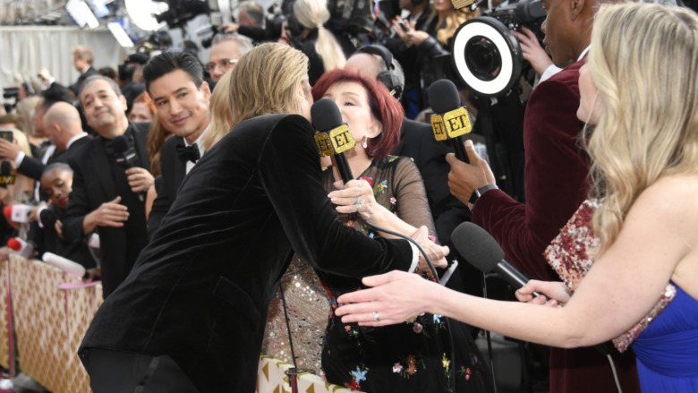 Brad Pitt and Sharon Osbourne embracing on the Oscars red carpet