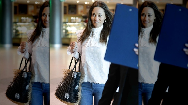 Pippa Middleton at an airport holding a bag